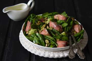 Salad with spinach, avocado and pumpkin seeds salted fish   