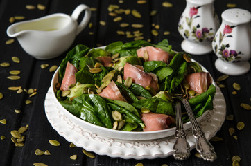 Salad with spinach, avocado and pumpkin seeds salted fish   