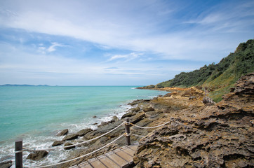 wood bridge and landscape of sea,stone, green mountain and blue sky beach in thailand