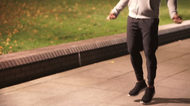 Athletic black male skipping in urban environment