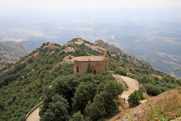 Fototapeta na wymiar MONTSERRAT, SPAIN - AUGUST 28, 2012: Saint Joan hermitage in Montserrat Mountain, Spain. Benedictine abbey Santa Maria de Montserrat in Monistrol de Montserrat