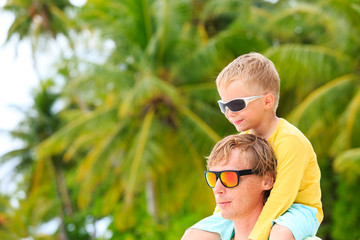 father and little son hug on summer beach