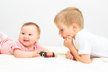 little girl and boy playing with toys