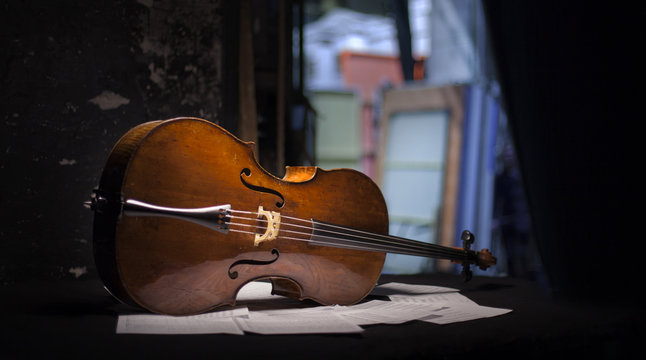 Vintage cello on wooden background