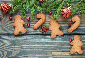 Christmas background. The concept of Christmas baking - gingerbread cookies, fir branches, red balls, star anise and cranberry
