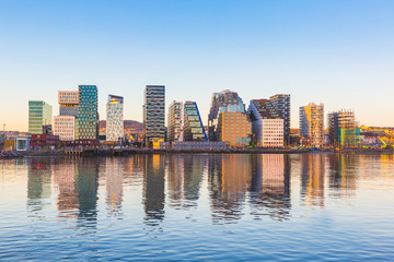 Modern buildings in Oslo with their reflection into the water - 97953302