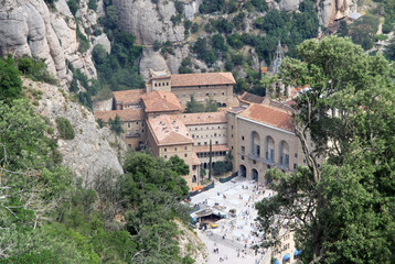 Fototapeta na wymiar MONTSERRAT, SPAIN - AUGUST 28, 2012: Benedictine abbey Santa Maria de Montserrat in Monistrol de Montserrat, Spain. View from the funicular de Sant Joan