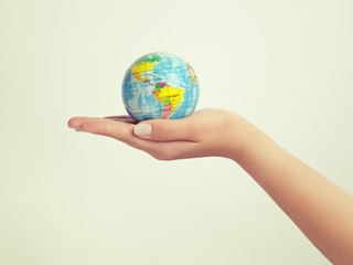female hand holding globe. save the earth concept