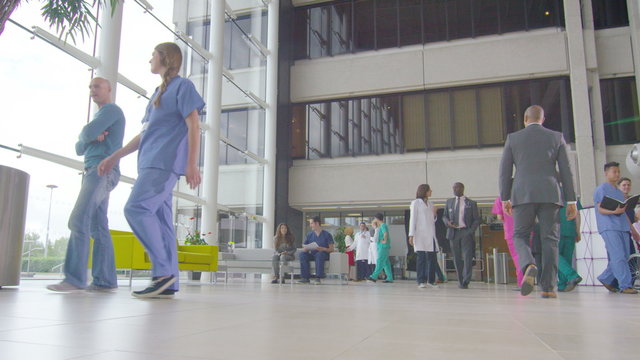  Time lapse of medical staff and patients in busy modern hospital