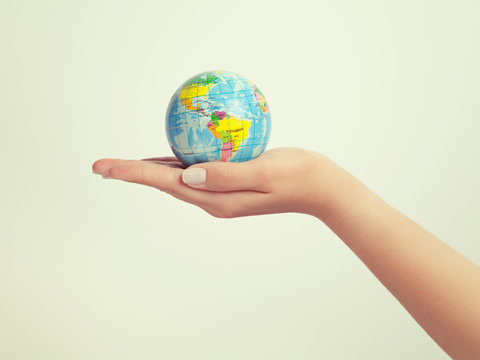 female hand holding globe. save the earth concept