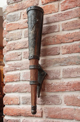 Stylized lamp in the form of the ancient torch on a brick wall.