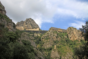 Fototapeta na wymiar MONTSERRAT, SPAIN - AUGUST 28, 2012: Benedictine abbey Santa Maria de Montserrat in Monistrol de Montserrat, Spain