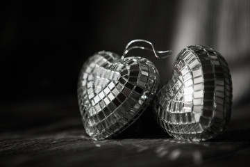 Shiny Valentine hearts on old wooden background
