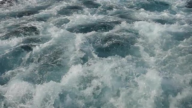 Powerful churning of water by boat motor is slow motion