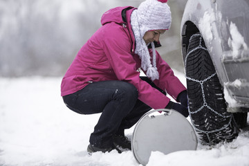 woman putting snow chains