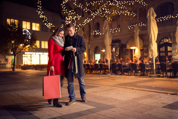 trendy couple is walking with shopping bag in the city center