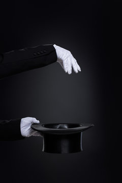 Magicianˈs Hands In White Gloves With Top Hat