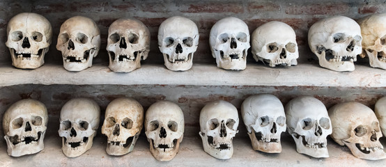 Human skulls inside a catacomb. - 97957700
