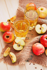 
apple cider with fresh apples , cinnamon , spices and chips on a wooden background