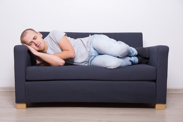 man sleeping on sofa at home