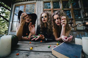 Three vintage witches perform magic ritual