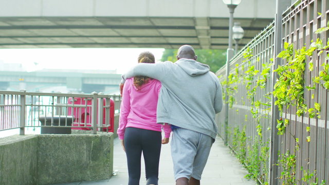  Personal trainer high fives his female client to celebrate her improvement