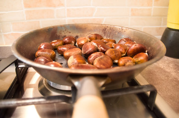 roasted chestnuts cooking on a pan