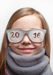Funny girl in funny glasses and a scarf with the inscription 2016