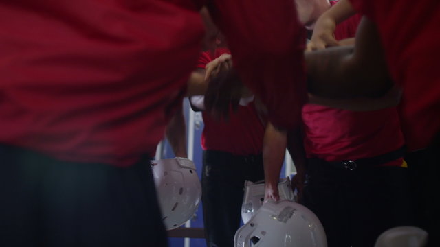  American football coach in locker room, psyching up players before the game