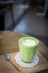 green tea latte on wood background