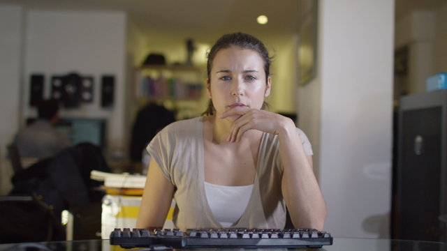  Office worker working at her computer as seen from computer screen's pov