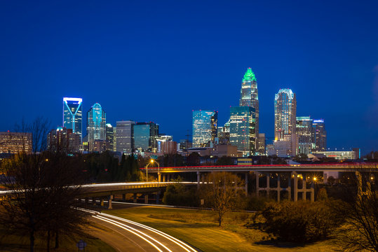 The top of the tallest tower in Charlotte, North Carolina lit up green in support of our military taken during the evening rush hour commute