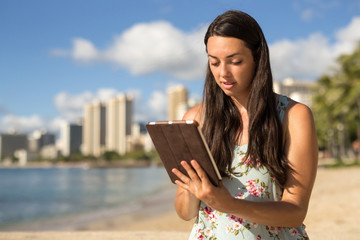 Young woman in Hawaii using tablet computer