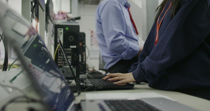 Team of workers in an electronics factory working on computer testing and repair