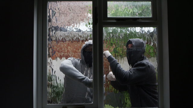  2 masked burglars breaking and entering into a victim's home