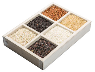 Rice and millet grains assortment in white box over white background