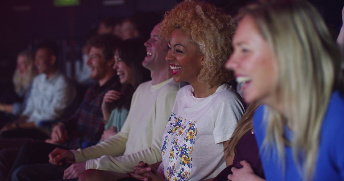  Theatre audience laughing at comedy show or funny movie