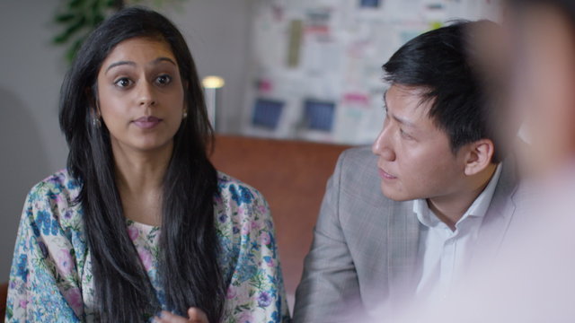  Attractive mixed ethnicity business team in discussion in office meeting