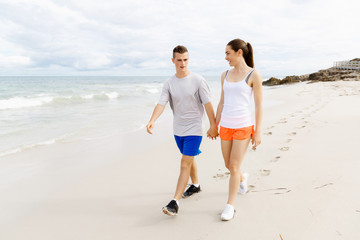 Fototapeta premium Runners. Young couple running on beach