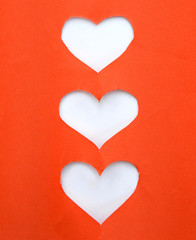 Stack of red torn paper in heart shape symbol over white background