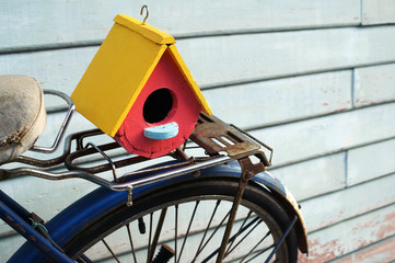colorful bird house on classic bicycle.