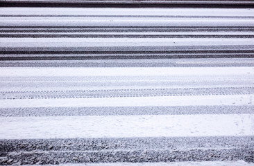 tyre prints in wet snow on asphalt