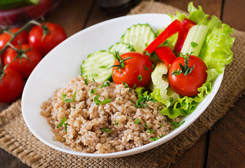 Porridge with fresh vegetables and lettuce. Healthy breakfast. Proper nutrition. Dietary menu.
