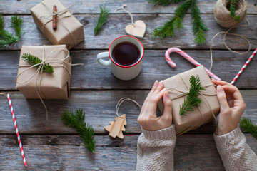 girl decorates the christmas gifts in a scandinavian style