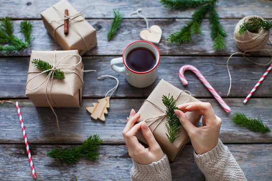 girl decorates the christmas gifts in a scandinavian style
