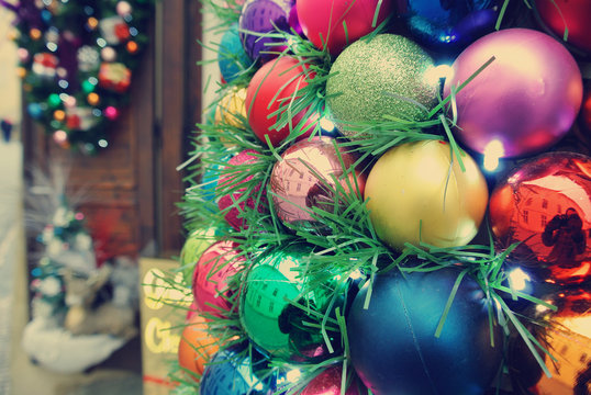 Colorful Christmas decorations in a store on the street. Image filtered in faded, retro style; nostalgic vintage concept of winter holidays.