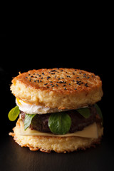 New ramen burger close-up on a black background. Vertical
