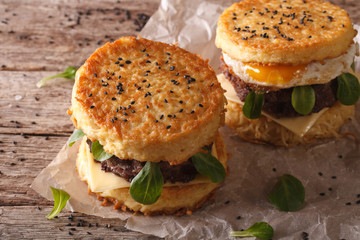 Ramen burgers with beef and egg on a wooden table. Horizontal
