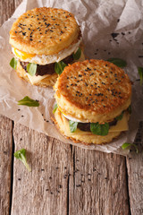 Ramen burgers with beef and egg on a wooden table. vertical
