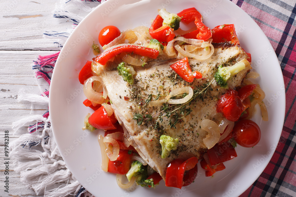 Wall mural baked flounder with vegetables closeup. Horizontal top view
